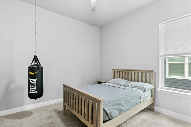 a bed sitting in a bedroom next to a window