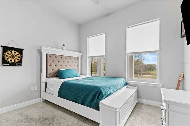 a bedroom with a bed lamp and a window