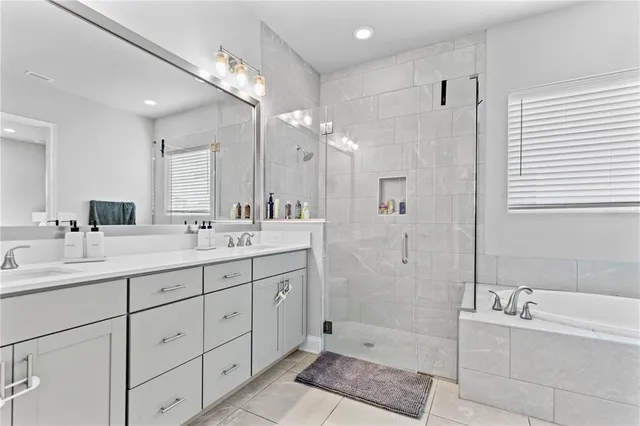 a bathroom with a double vanity sink mirror and shower