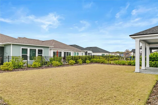 a view of house with yard and outdoor seating