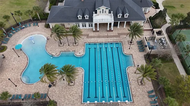 an aerial view of a house with garden space and swimming pool