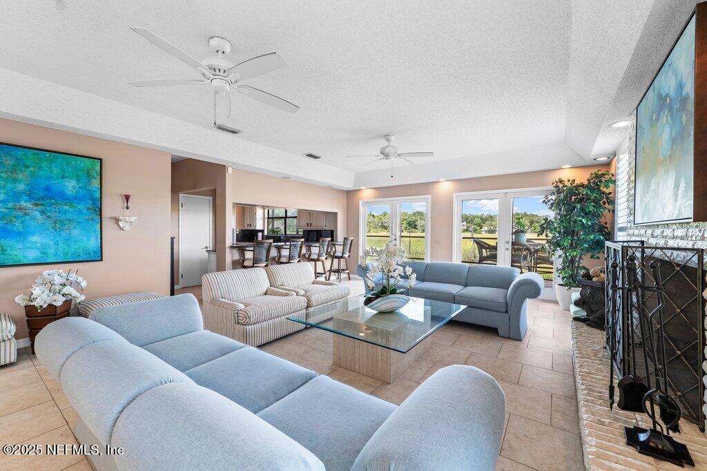 2010 Shadow Lane Neptune Beach, FL 32266 - Photo 14 of 61 a living room with furniture ceiling fan and a fireplace