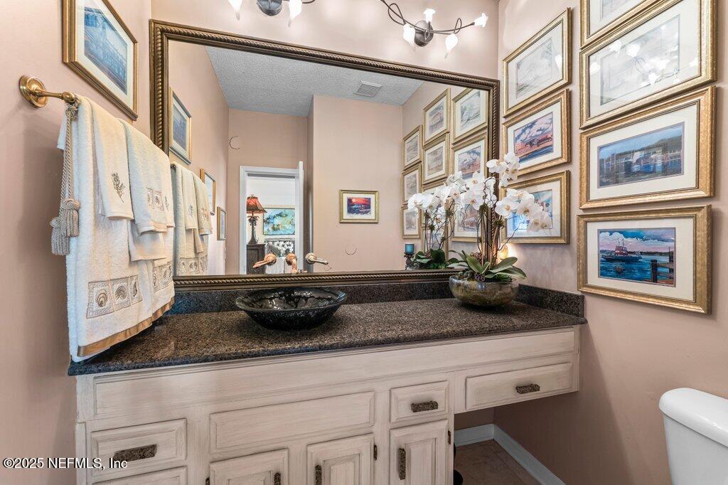 2010 Shadow Lane Neptune Beach, FL 32266 - Photo 18 of 61 a bathroom with a granite countertop sink a toilet and a window