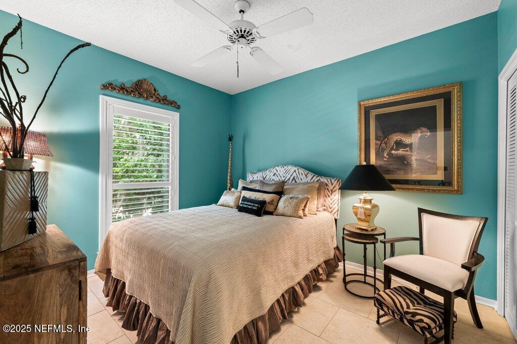 2010 Shadow Lane Neptune Beach, FL 32266 - Photo 38 of 61 a bedroom with a bed and a chandelier