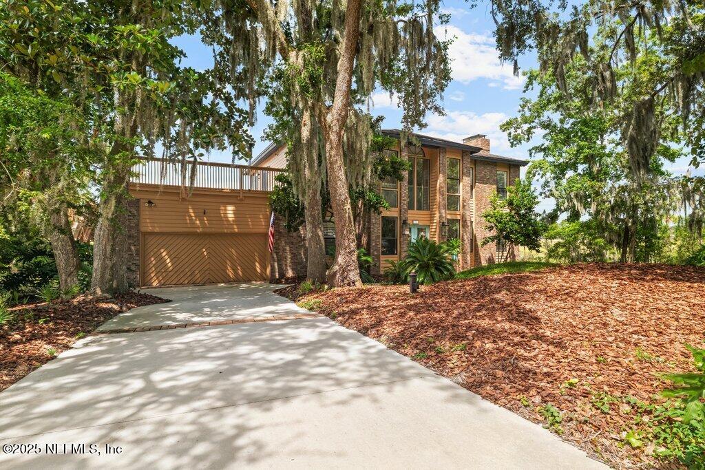 2010 Shadow Lane Neptune Beach, FL 32266 - Photo 58 of 61 a front view of a house with a yard and garage