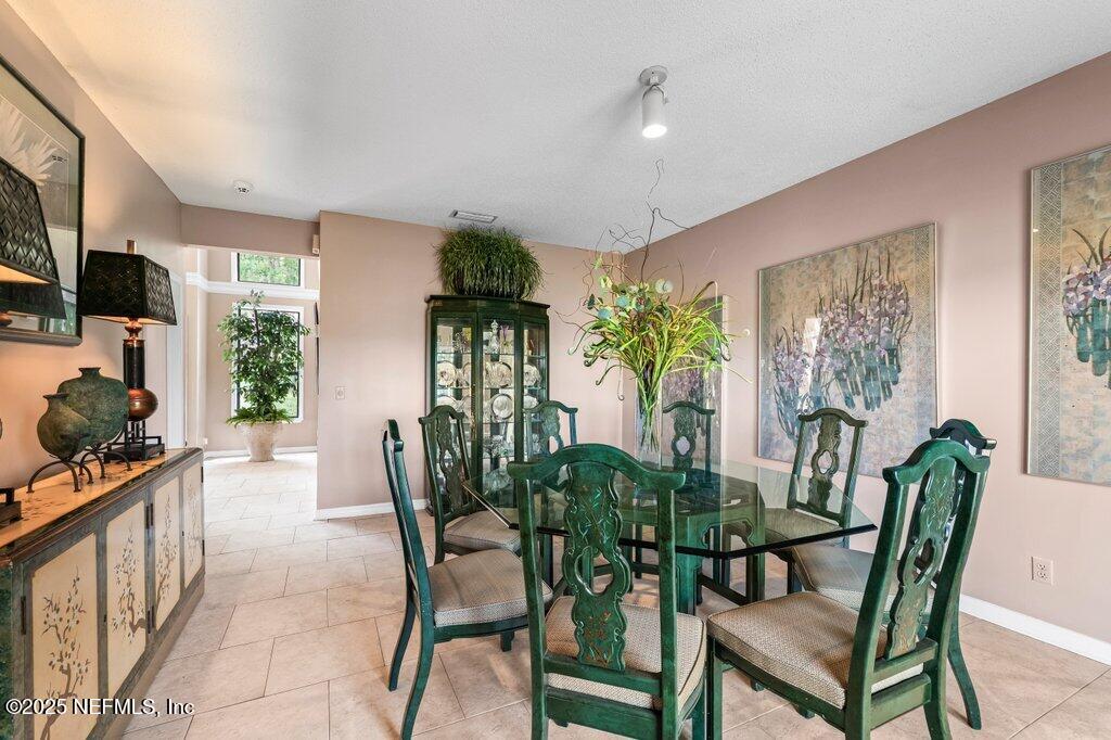 2010 Shadow Lane Neptune Beach, FL 32266 - Photo 7 of 61 a view of a dining room with furniture and a flat screen tv