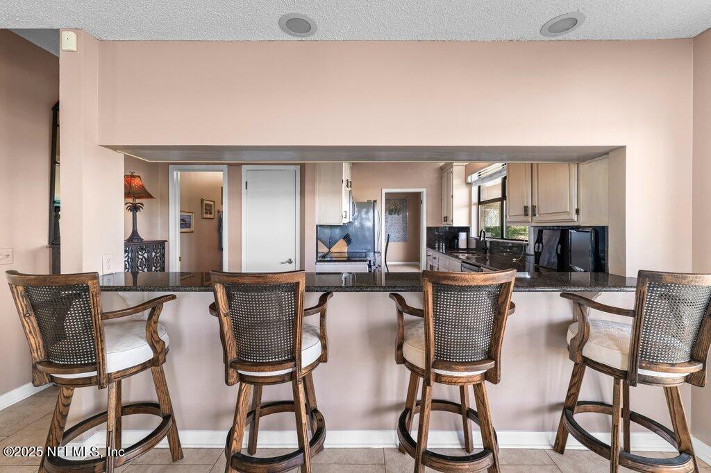 2010 Shadow Lane Neptune Beach, FL 32266 - Photo 9 of 61 a dining room with chairs and view kitchen