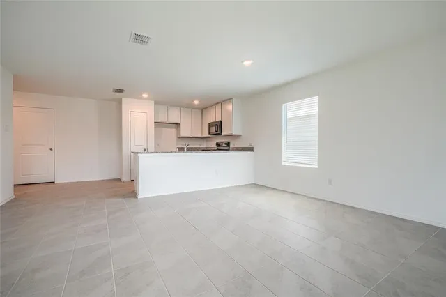 a view of a kitchen with a sink cabinets and a window