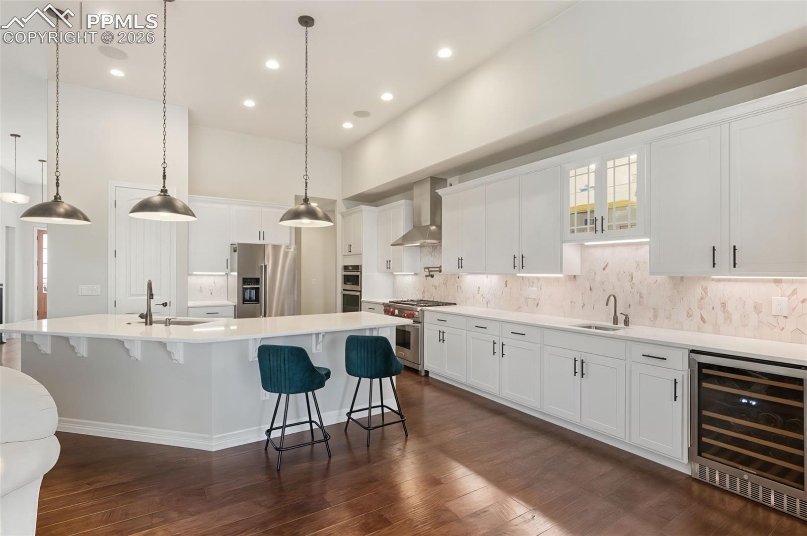 5318 Rocking Tree Grove Colorado Springs, CO 80906 - Photo 7 of 49 A true culinary workspace, this layout boasts extensive counter space, under-cabinet lighting, and an under-counter wine fridge to keep vintages at the perfect temperature for immediate serving