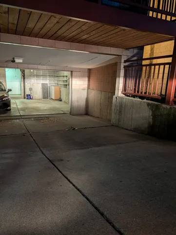 a kitchen with a refrigerator and white cabinets