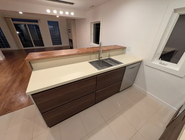 a view of a bedroom with wooden floor and staircase