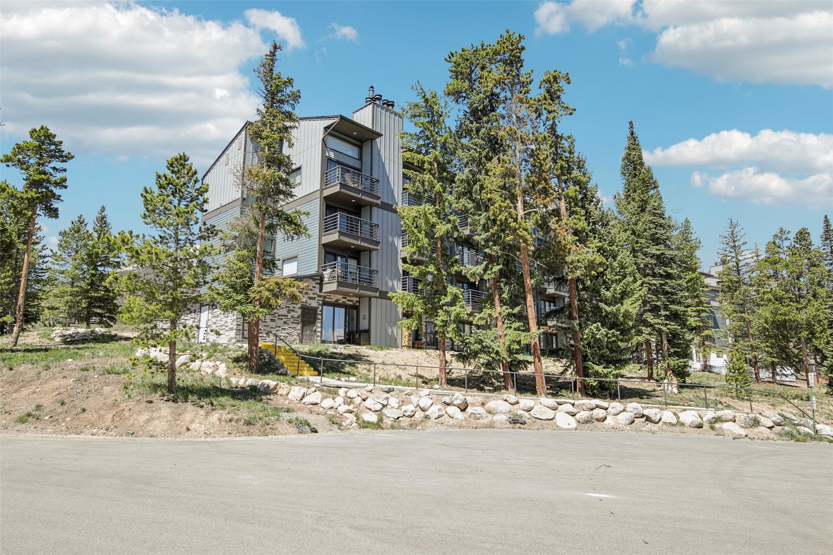 89310 Ryan Gulch Road, Unit 103 Silverthorne, CO 80498 - Photo 23 of 48 a building with trees in front of it
