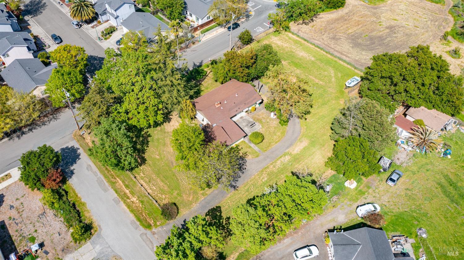 an aerial view of residential house with swimming pool and lawn chairs