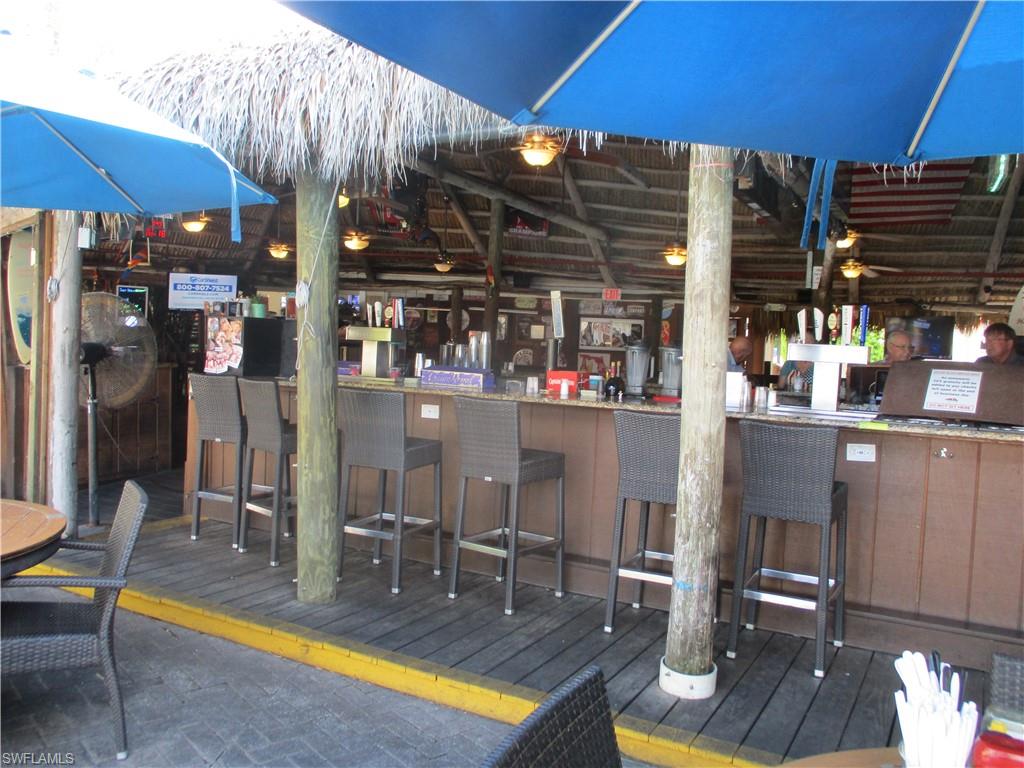 2555 9th Street North, Unit 131 Naples, FL 34103 - Photo 12 of 17 a view of a swimming pool with outdoor seating