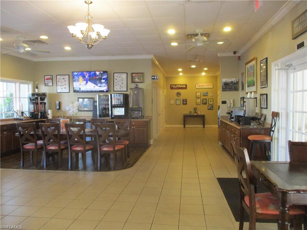 2555 9th Street North, Unit 131 Naples, FL 34103 - Photo 14 of 17 a view of a dining room with furniture