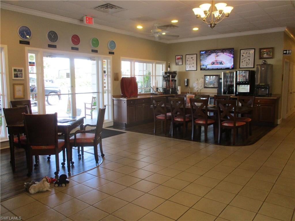 2555 9th Street North, Unit 131 Naples, FL 34103 - Photo 15 of 17 a view of a dining room with furniture