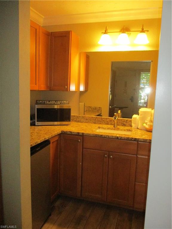 2555 9th Street North, Unit 131 Naples, FL 34103 - Photo 4 of 17 a bathroom with a sink and a mirror