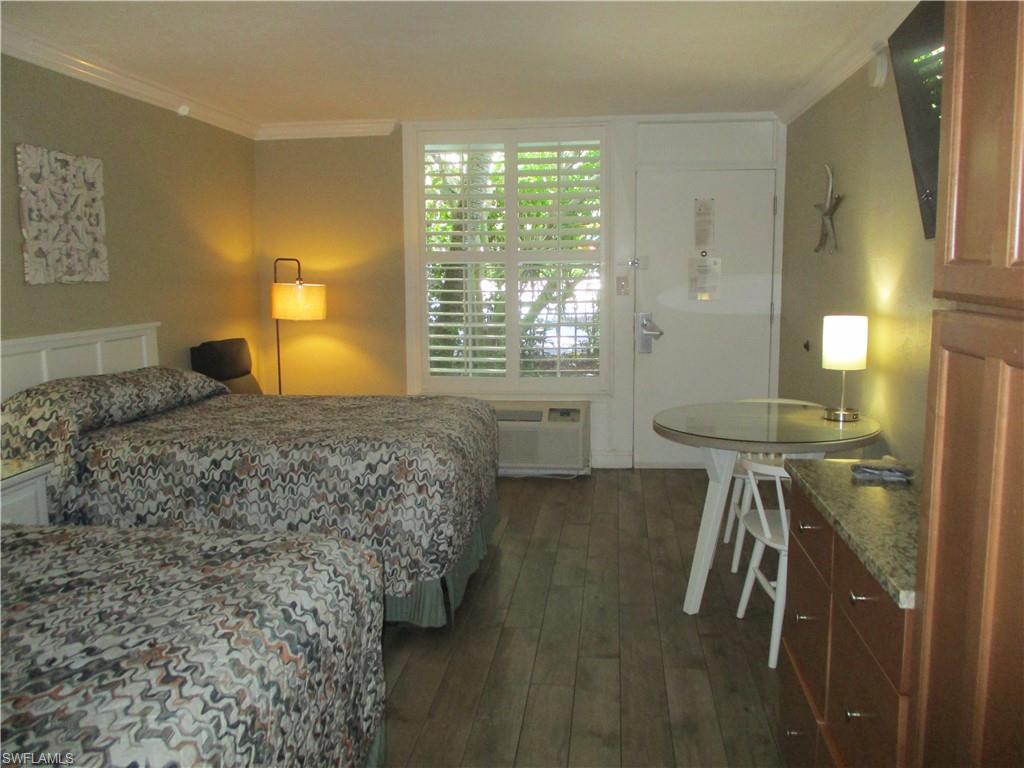 2555 9th Street North, Unit 131 Naples, FL 34103 - Photo 5 of 17 a bedroom with a bed and window