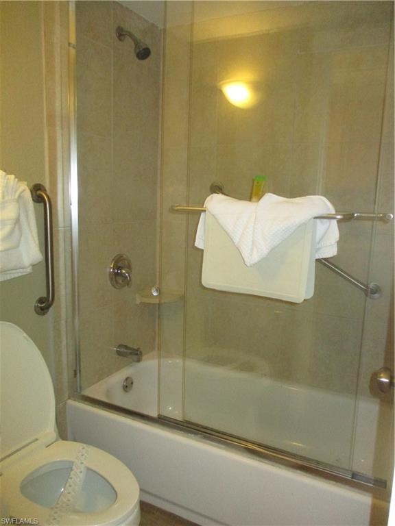2555 9th Street North, Unit 131 Naples, FL 34103 - Photo 9 of 17 a bathroom with a shower and toilet