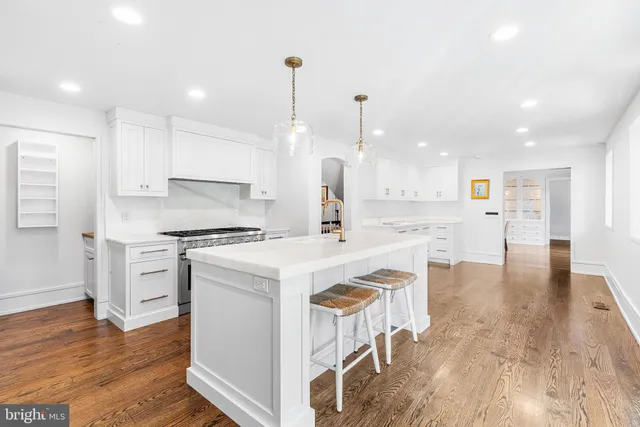 a kitchen with a stove a sink and a refrigerator