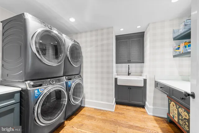 a utility room with sink dryer and washer