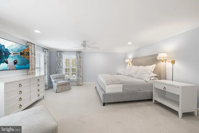 a large white room with a large window and chandelier