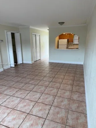 a view of a livingroom with wooden floor and a window