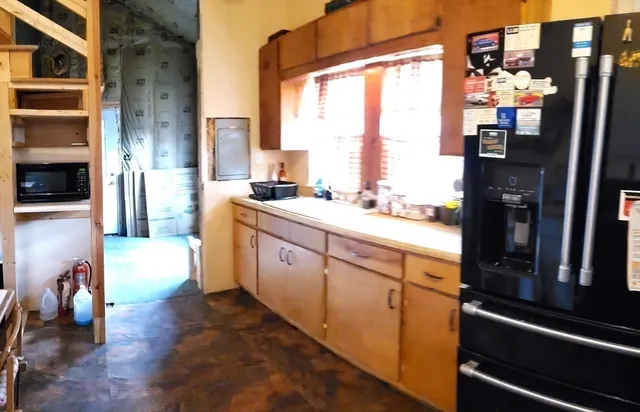 a kitchen with a sink appliances and cabinets