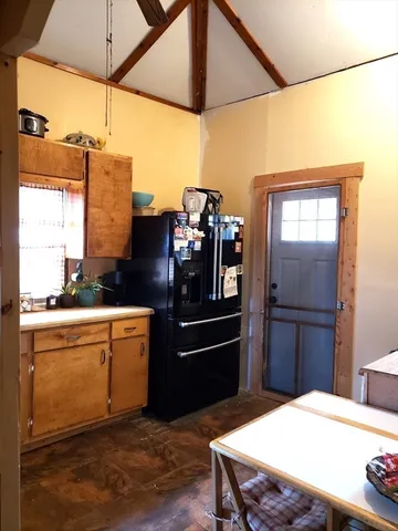 a kitchen with a refrigerator and countertop