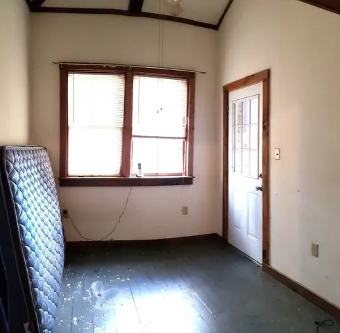 a view of a room that has a chair and a window in it