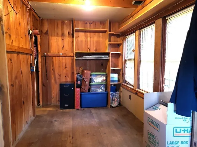 a view of hallway with furniture and a window