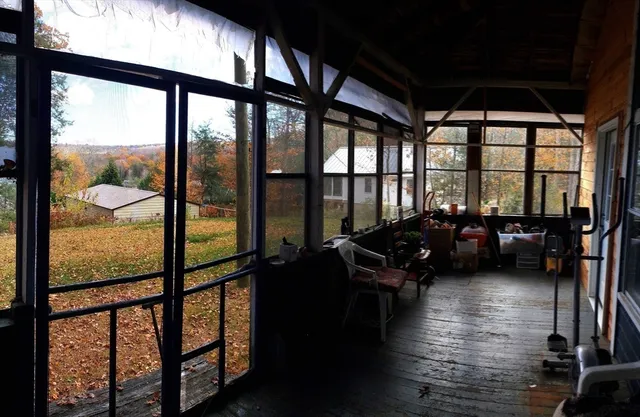 a living room with furniture and floor to ceiling windows