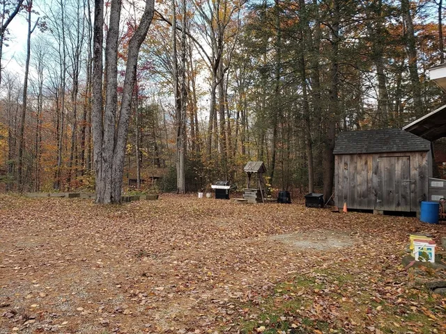 a backyard of a house with parked trees