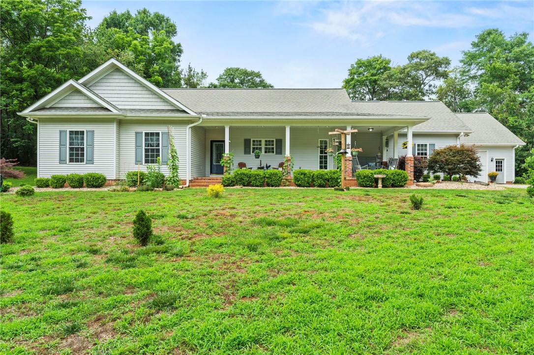 160 Sentell Road Williamston, SC 29697 - Photo 1 of 45 A classic ranch home nestled among lush trees, featuring a welcoming full-length covered porch.