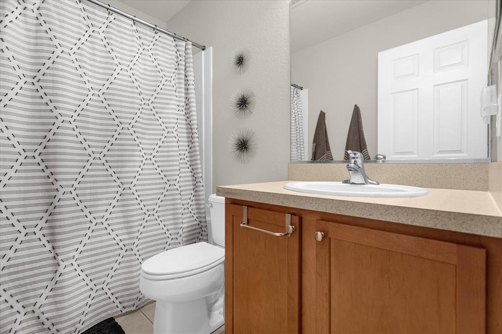 5781 Southwest 39th Street Ocala, FL 34474 - Photo 22 of 45 a bathroom with a sink a toilet and shower