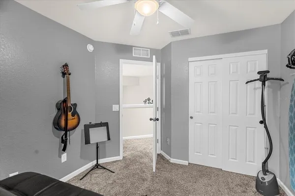 a bedroom with a bed and large window