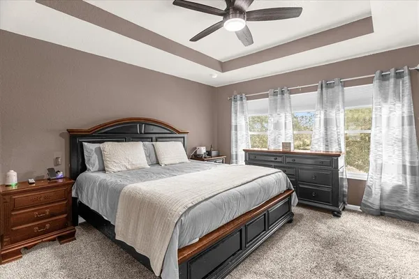 a bedroom with a bed and a ceiling fan