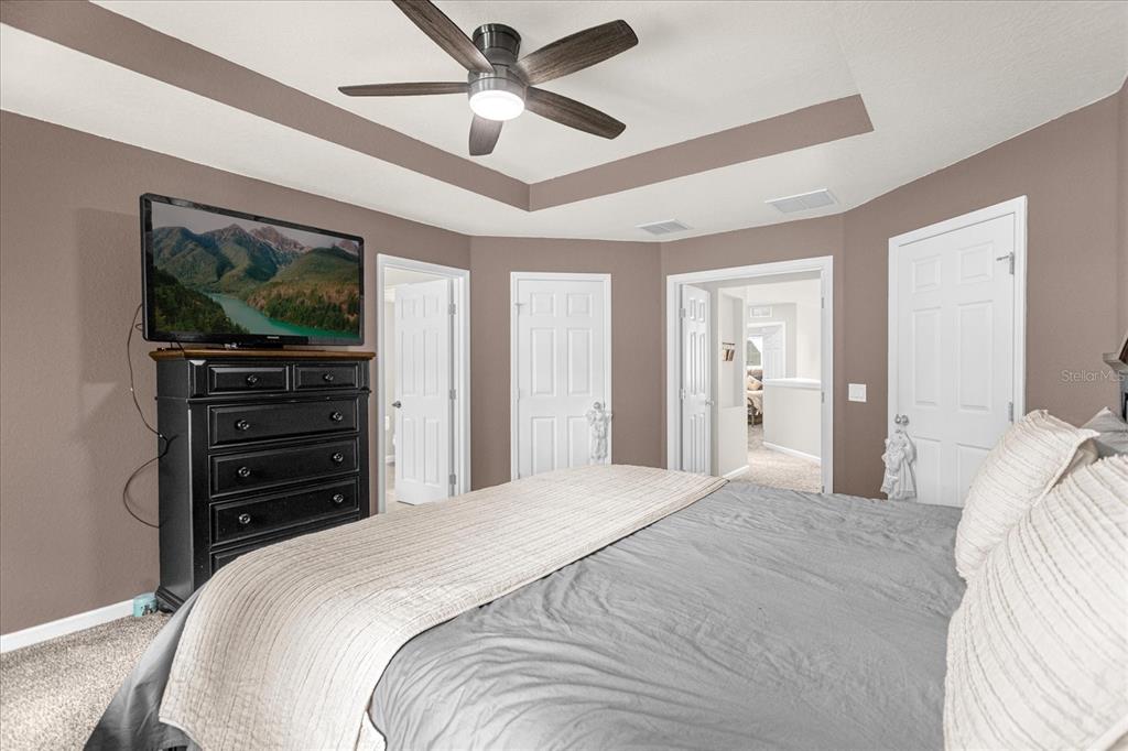 5781 Southwest 39th Street Ocala, FL 34474 - Photo 27 of 45 a bedroom with a bed and a flat screen tv