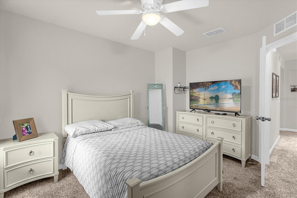 5781 Southwest 39th Street Ocala, FL 34474 - Photo 30 of 45 a bedroom with a bed and a flat screen tv