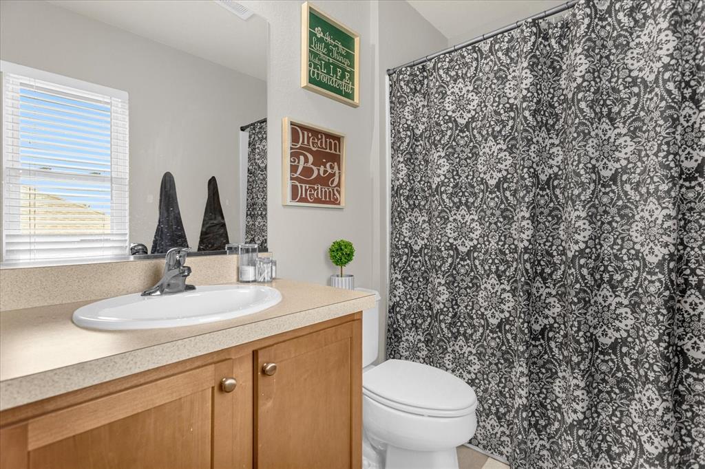 5781 Southwest 39th Street Ocala, FL 34474 - Photo 32 of 45 a bathroom with a granite countertop toilet sink and mirror