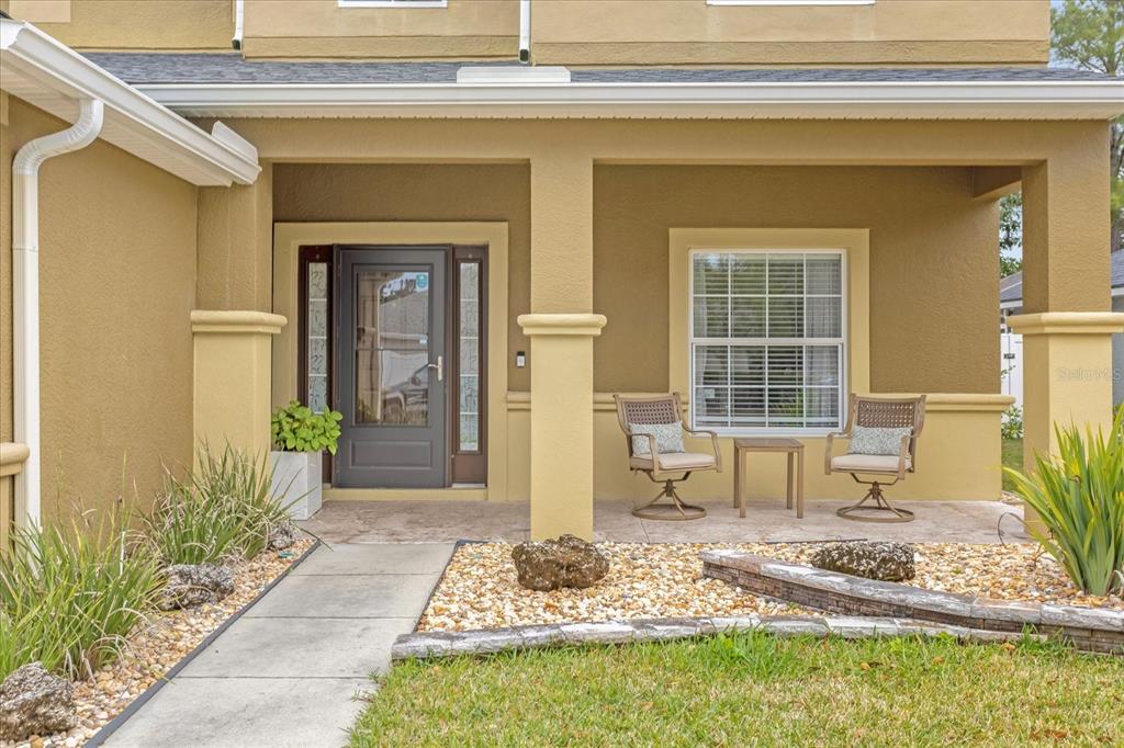 5781 Southwest 39th Street Ocala, FL 34474 - Photo 4 of 45 a front view of a house with outdoor seating