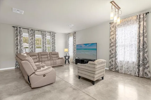 a living room with furniture and a large window