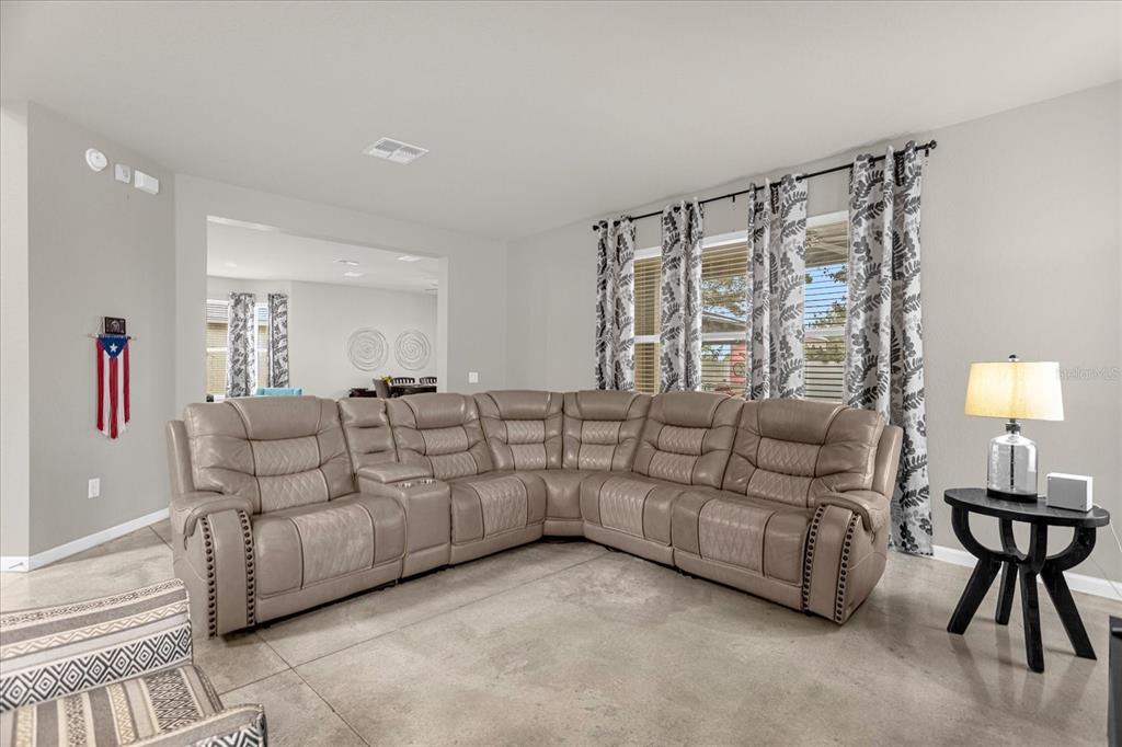 5781 Southwest 39th Street Ocala, FL 34474 - Photo 8 of 45 a living room with furniture and a large window