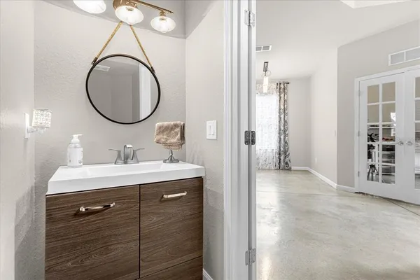 a bathroom with a sink and a mirror