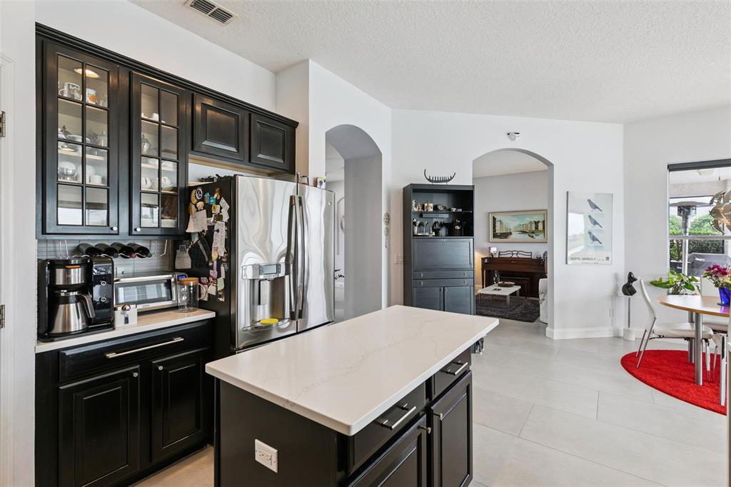 1652 Cherry Ridge Drive Lake Mary, FL 32746 - Photo 16 of 62 a kitchen with stainless steel appliances kitchen island granite countertop a refrigerator a stove top oven and sink