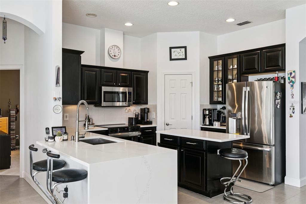 1652 Cherry Ridge Drive Lake Mary, FL 32746 - Photo 19 of 62 a kitchen with stainless steel appliances a stove a sink a microwave a refrigerator and cabinets