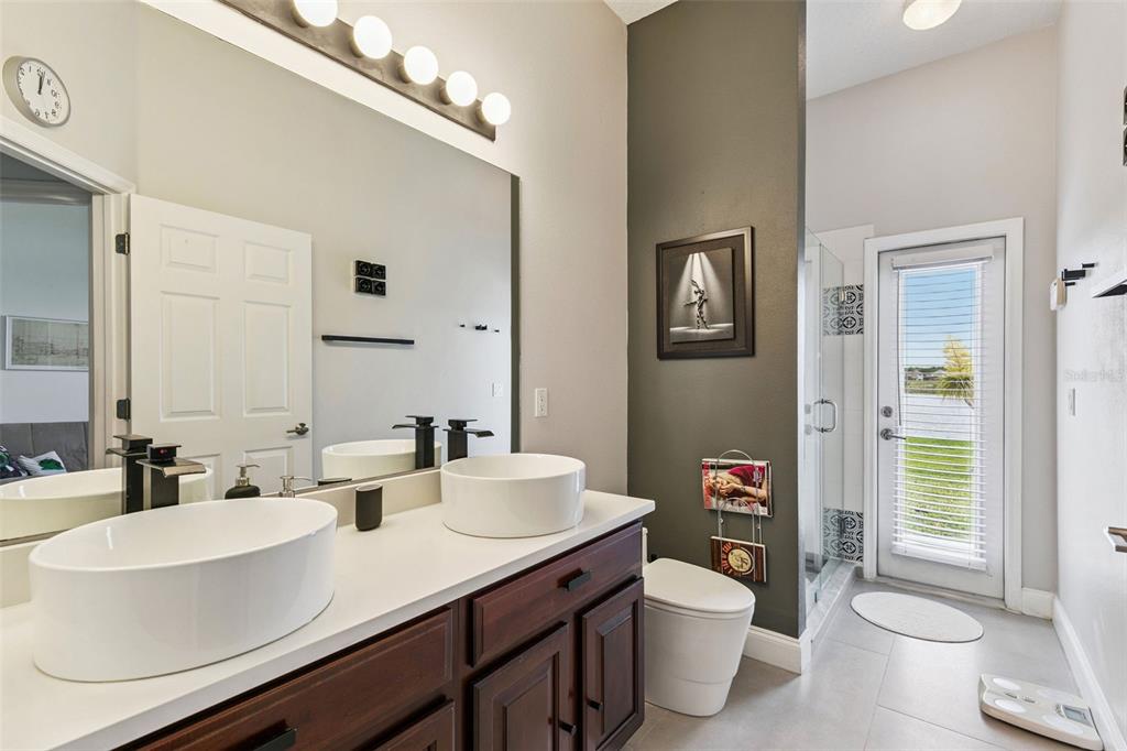 1652 Cherry Ridge Drive Lake Mary, FL 32746 - Photo 27 of 62 a bathroom with a double vanity sink toilet and a mirror