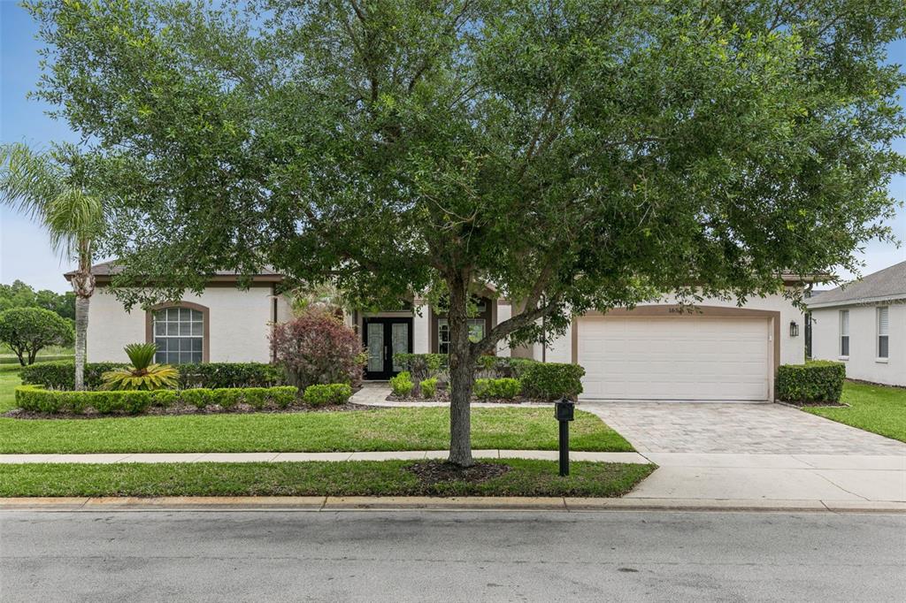 1652 Cherry Ridge Drive Lake Mary, FL 32746 - Photo 3 of 62 a white house that has a tree in front of it