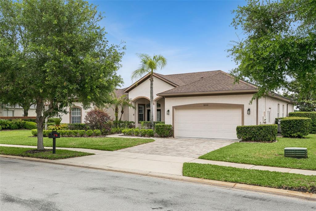 1652 Cherry Ridge Drive Lake Mary, FL 32746 - Photo 5 of 62 a view of a white house next to a yard and large trees