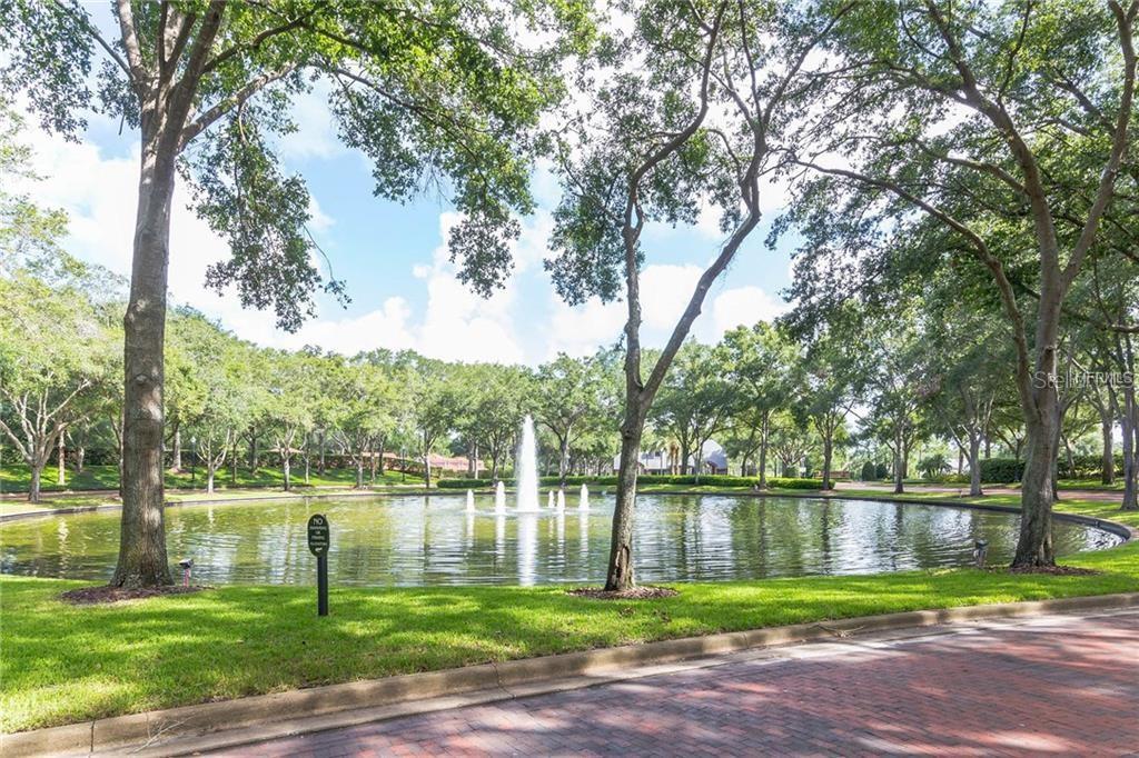 1652 Cherry Ridge Drive Lake Mary, FL 32746 - Photo 54 of 62 a view of a lake with a big yard and large trees